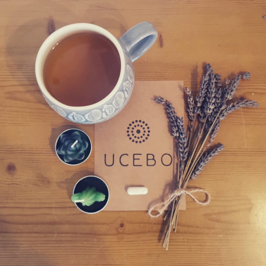 UCEBO health supplement pill with tea, lavender, and candles