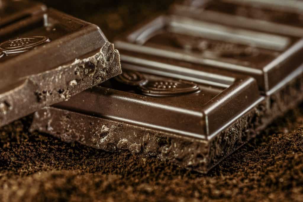 Close-up shot of dark chocolate bar pieces resting against each other 